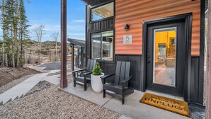 A modern building with a wooden exterior, numbered 5, featuring a bench and a potted plant outside. - Unwind and Unplug at #5 Tiny Cabin (Brian Head)