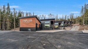 A modern tiny home resort with a wooden exterior and large windows. - Unwind and Unplug at #5 Tiny Cabin (Brian Head)