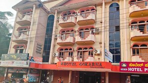 A multi-story building with a prominent sign for Hotel Gokarna. - Hotel Gokarna International (Kumta)