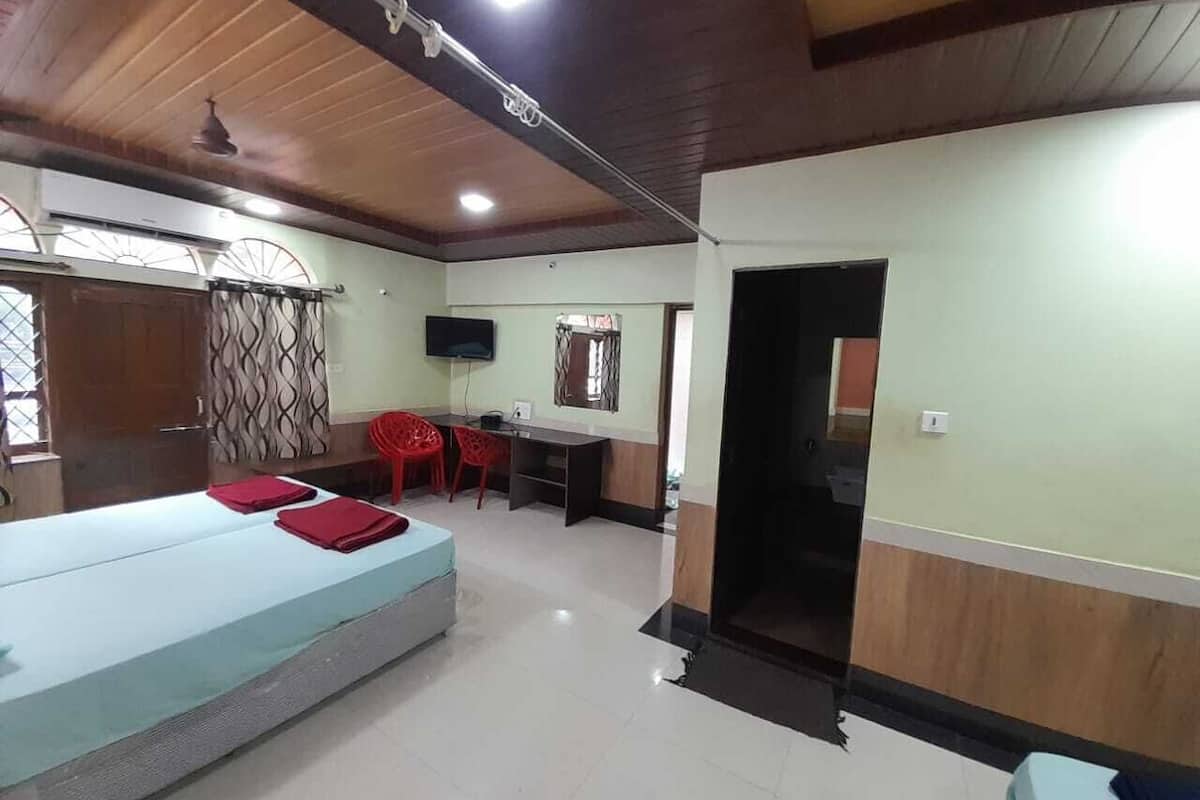 A room with a bed, a desk, and a TV.