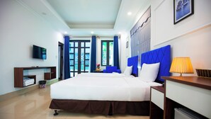 A hotel room with a large bed, a desk with a lamp, a TV on the wall, and a view of the outdoors through the window. - Hanoi Shining House (Hanoi)