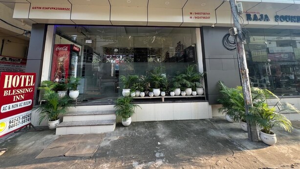 A hotel named "HOTEL BLISSING" with a signboard, AC & NON AC room availability, and a Coca-Cola advertisement. - Hotel Blessing Inn (Jalandhar)