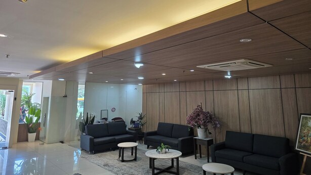 A modern lobby with a reception desk, black sofas, and a large potted plant. - Hotel Seri Warisan Melaka, Stadium Hang Tuah (Malacca City)