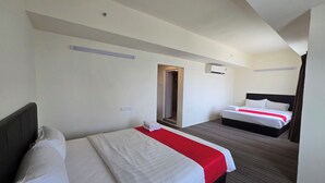A hotel room with two beds, a red accent bed runner, a dark headboard, and a neutral color scheme. - Hotel Seri Warisan Melaka, Stadium Hang Tuah (Malacca City)