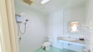 A small, clean bathroom with a toilet, sink, and shower. - Baan Bonsuan Hill Guesthouse (Kathu)