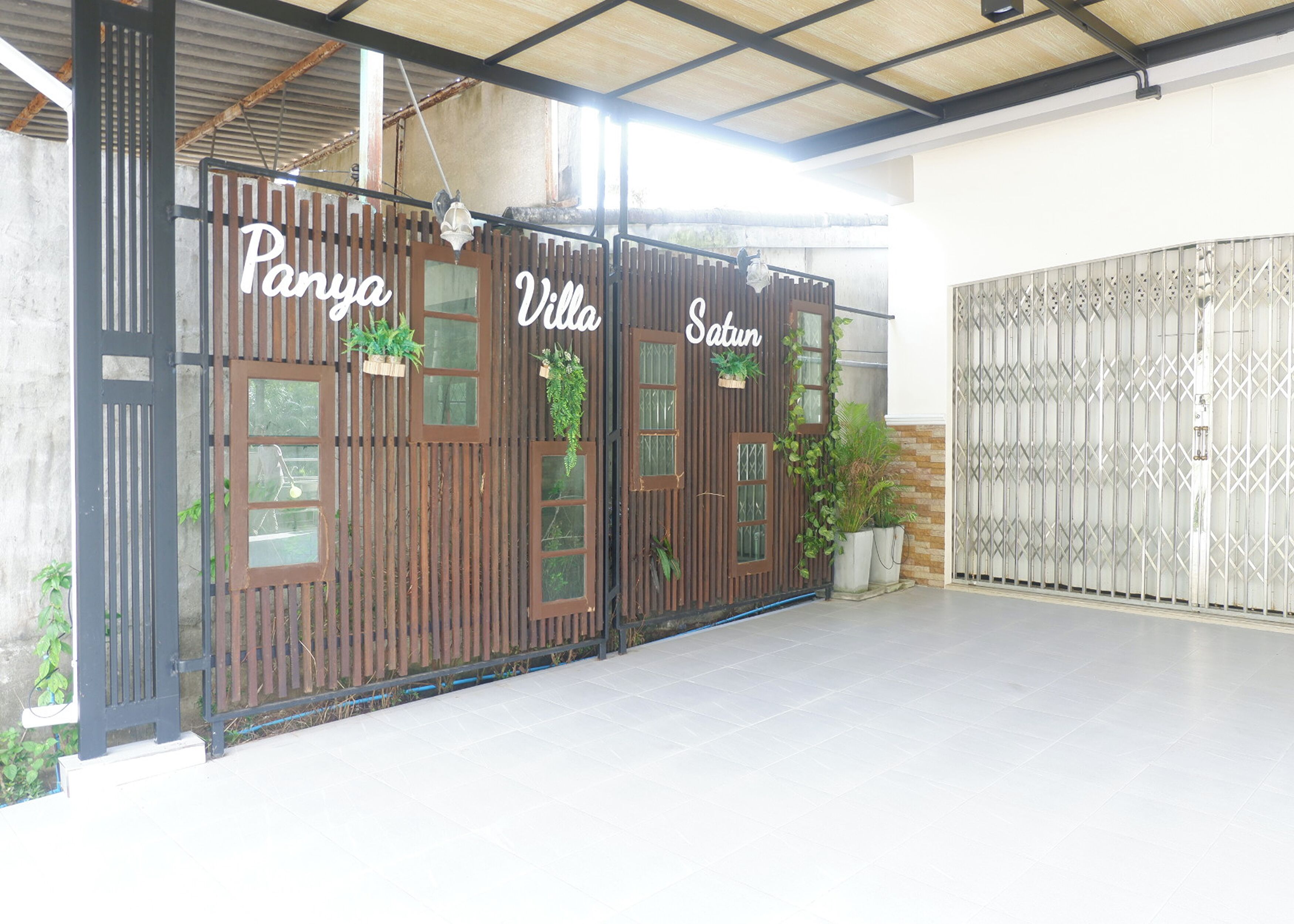 A gated entrance with the name 'Panya Villa' and 'Satin' visible on the gate.