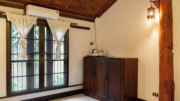 A room with a large window, wooden ceiling, and a cabinet. - Romsak Lanna Resort (Hang Dong)