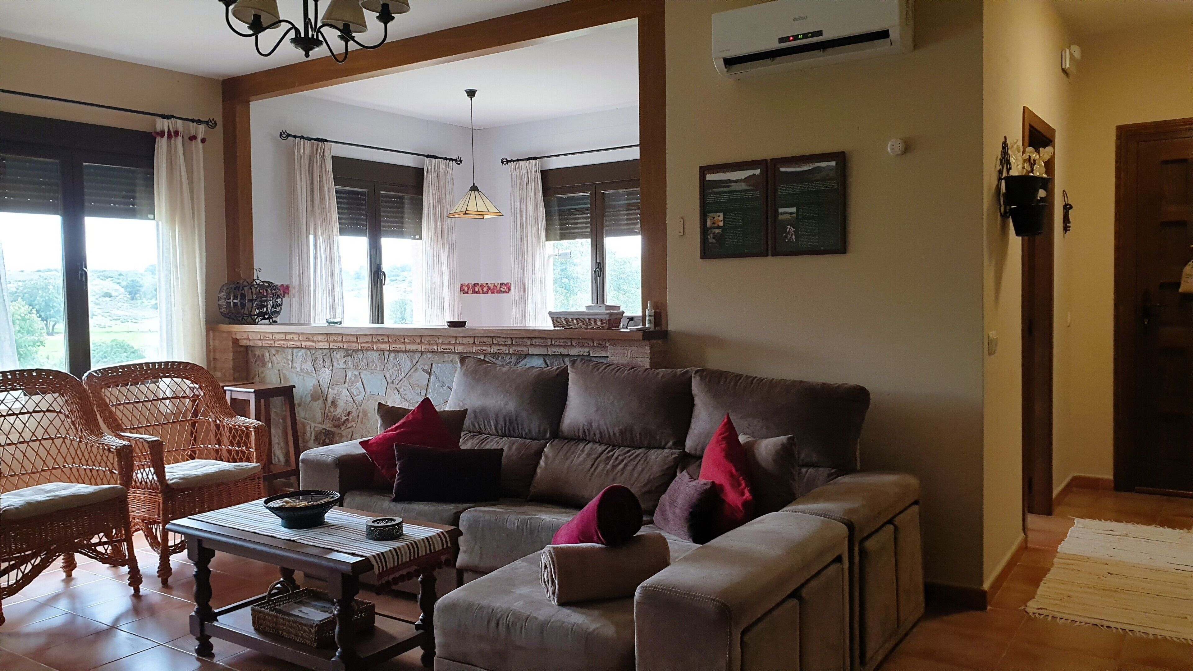 A living room with a sofa, chairs, a coffee table, and a fireplace.