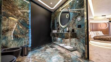 Deluxe Suite | Bathroom | Hair dryer, slippers, towels, soap