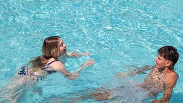 A swimming pool with clear water and visible ripples.