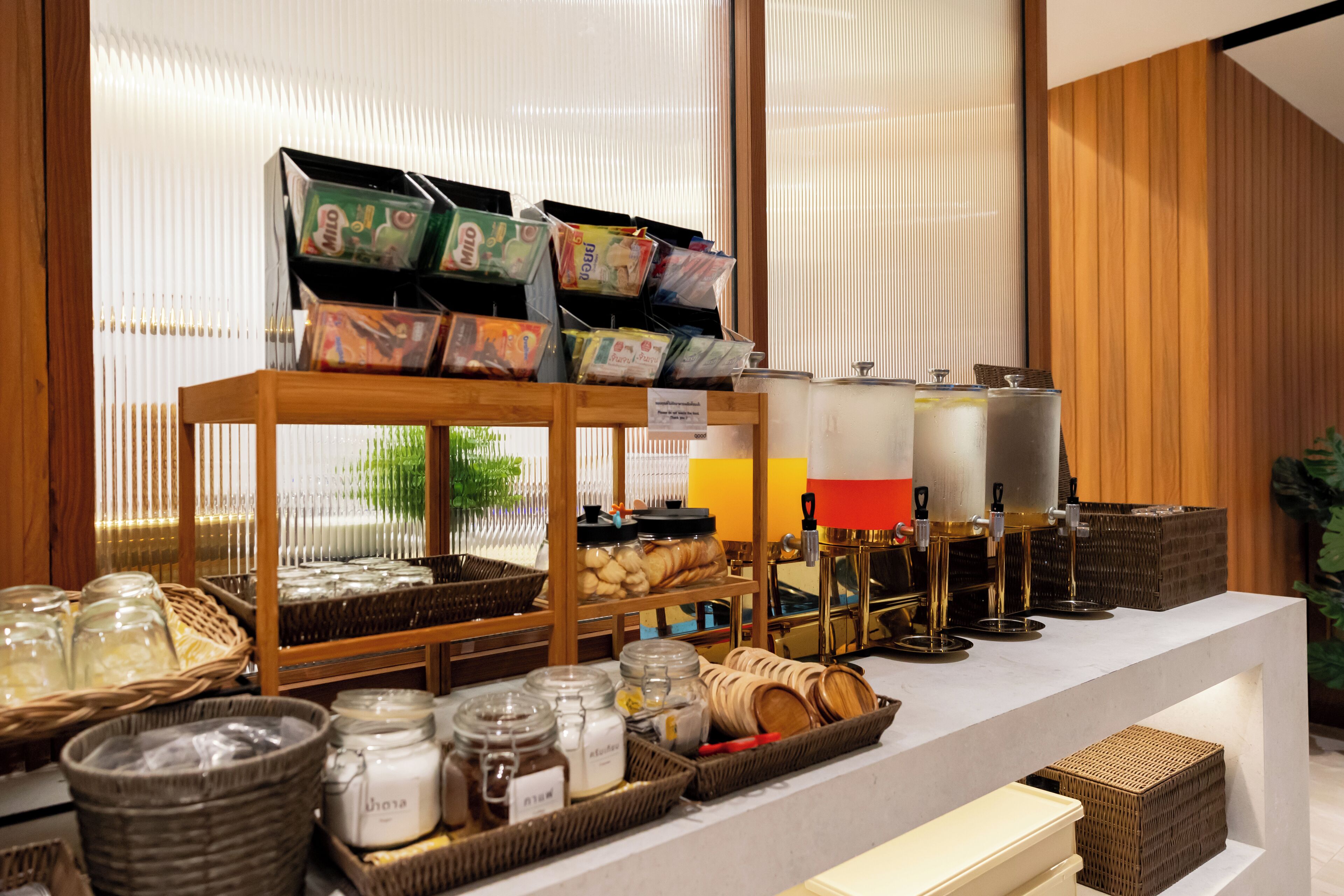 A bakery display with various baked goods and jars of spreads.