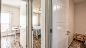 A bedroom with a bed, a desk, and a chair. - Casa El Puerto by Huskalia (Tazacorte)