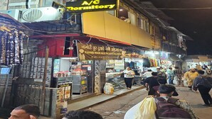 A street scene with a building featuring a sign for a hostel. - Classy Ac Dormitory (Mumbai)