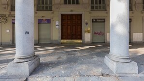 A building entrance with a large wooden door, flanked by two stone columns, and a sign indicating a restaurant. - Ai Portici di Susa - Classy by Wonderful Italy (Turin)