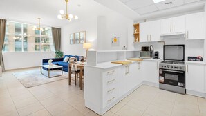 A modern apartment with a kitchen, dining area, and living room.