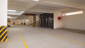 A spacious, well-lit indoor area with a clear path leading to a staircase and a sign for Hotel El Rifaya.