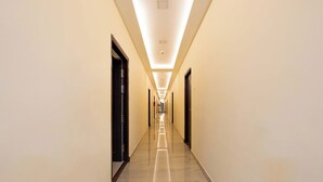 A long, narrow hallway with a polished floor and light-colored walls.