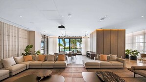 A spacious living area with a large sectional sofa, a coffee table, and a dining table with chairs.