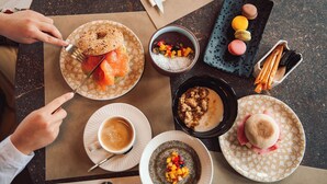 A table with various food items and a cup of coffee, suggesting a dining setting.
