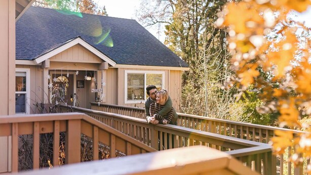 A house with a wooden deck and a covered porch. - Eagle Retreat ~ Mountain Escape • New • With AC (Shaver Lake)
