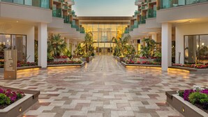 A hotel lobby with a central open space, multiple floors, and a modern design.