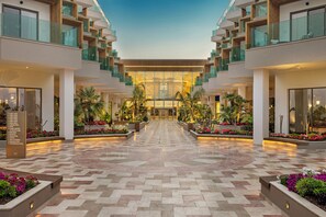 A hotel lobby with a central open space, multiple floors, and a modern design.