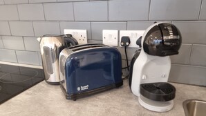 A kitchen with a toaster, kettle, and coffee maker on the counter. - Large Duplex 7 Adults at London Bridge (London)