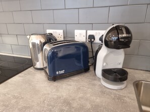 A kitchen with a toaster, kettle, and coffee maker on the counter. - Large Duplex 7 Adults at London Bridge (London)