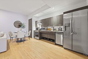 A modern kitchen with a built-in oven, microwave, and stainless steel refrigerator. - Bright Resort Style 1BR Heart of Miami Downtown (Miami)