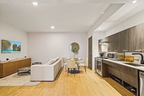 A modern apartment with a living area, dining space, and kitchen.