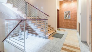 Eine Treppe mit Metallgeländern und einer Topfpflanze am Fuß.