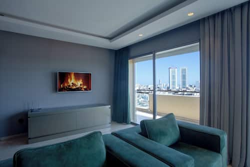 Deluxe Penthouse, Balcony, City View | Living area | TV