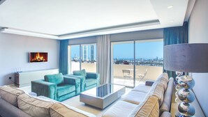 A modern living room with a sofa, a coffee table, and a TV mounted on the wall. - W-Aldorf (Casablanca)