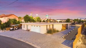A modern building with a flat roof, a covered outdoor seating area, and a paved driveway. - Beachside Container Tiny Home Saltwater Oasis (Fort Walton Beach)