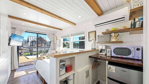 A compact kitchen with modern appliances, a built-in oven, and a microwave.