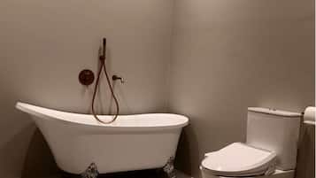 Luxury Suite | Bathroom | Hair dryer, slippers, towels, toilet paper