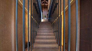 A long, narrow hallway with wooden floors and metal railings on either side. - Nearchou Boutique Hotel (Chania)