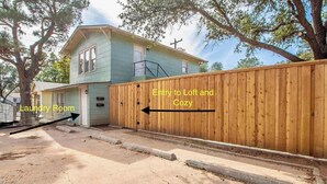 A house with a laundry room and a wooden fence. - The Loft - 1BR/1BA - Close to TTU (Lubbock)