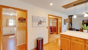 A spacious kitchen with wooden cabinets and a countertop. - Fish, Hike & Sightsee: Lovely Florissant Cabin! (Florissant)