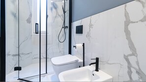 A modern bathroom with a glass-enclosed shower, a white toilet, and a sink with a black faucet. - Italianway Collection - Cola Montano 29 B (Milan)