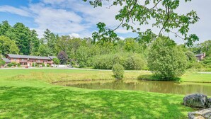 A serene lakeside property with a large house, a pond, and lush greenery. - Quiet Catskill Getaway w/ Fire Pit - Near Hiking! (Catskill)