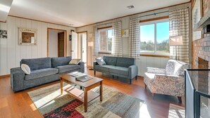 A spacious living room with two sofas, a coffee table, and a patterned rug. - Quiet Catskill Getaway w/ Fire Pit - Near Hiking! (Catskill)