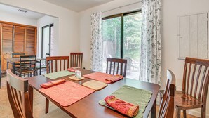 A dining area with a wooden table, chairs, and a window with curtains. - Quiet Catskill Getaway w/ Fire Pit - Near Hiking! (Catskill)