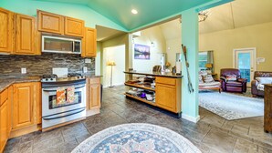 A spacious kitchen with wooden cabinets, a built-in microwave, and a large island with a sink. - Ski, Fish & Explore: Packwood Home w/ Sauna! (Packwood)