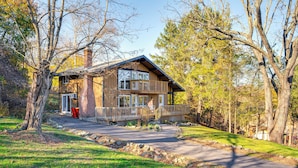 A two-story wooden cabin with a balcony, surrounded by trees and a stone pathway. - Walk to Liberty Mountain: Lake-view Ski Retreat! (Fairfield)