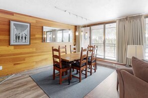 Enjoy a comfortable stay in this well-appointed room with a dining table, sofa, and large window offering a view of the outdoors.
