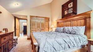 A bedroom with a wooden bed, a nightstand, a dresser, and a wardrobe. - 8712 Ski Tip Townhomes 3 Bedroom Townhouse (Keystone)