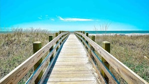 A wooden boardwalk leading to a beach with clear skies. - 🐠🌞Oceanfront | Corner Unit | Resort Amenities | Seaside Resort 603 (North Myrtle Beach)