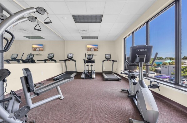 A gym with treadmills, elliptical machines, and weight equipment. - 🌴🐠Lazy River + Indoor/Outdoor Pools | Oceanfront | South Wind 205 (Myrtle Beach)