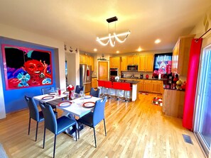 A modern kitchen with wooden cabinets, a stainless steel refrigerator, and a microwave. - GolfSim HotTub PS5 Sauna Thtr Pooltbl 6BR 5BA 420 (Thornton, CO, 80602)